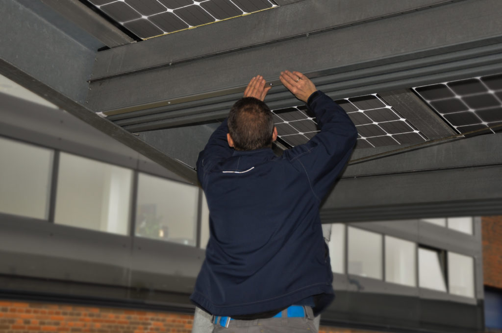Linear lighting panel, Tracy being mounted on soler carport roof, by hand